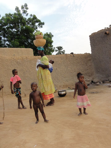Woman carrying a child and things on her head
